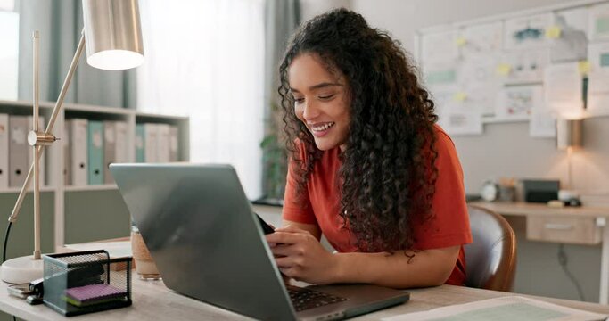 Laptop, phone and design with a woman in a small business office working on an artistic project. Mobile, computer and smile with a happy young designer in a studio workshop of a startup company
