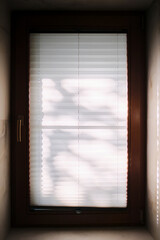Sun glare on a pleated white curtain.