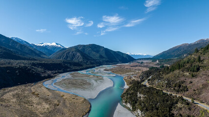 The bright blue water flowing through the braided river in a South Island mountain pass