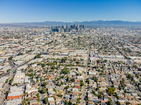 Los Angeles, California &ndash; October 6, 2023: aerial drone wide view toward 27th St historic district, south-central, with LA downtown center, homes, houses, apartments, buildings