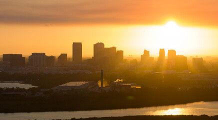 Aerial view of downtown district of Tampa city in Florida, USA at sunset. Dark silhouette of high...