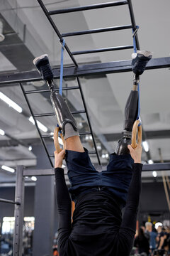 gorgeous athlete doing intense workout at the gym on gymnastic rings cropped shot,coordination, Spiderman