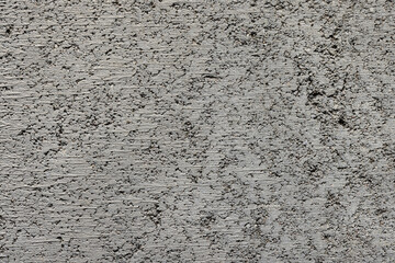 Background, photo of a texture from a building material of gray color, concrete, close-up