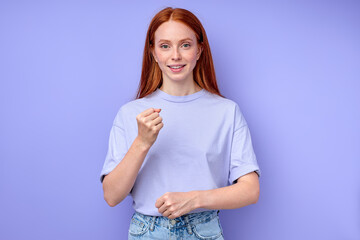 happy awesome ginger girl talking with gestures, clenching fists, looking at camera, explaining something with hands close up portrait