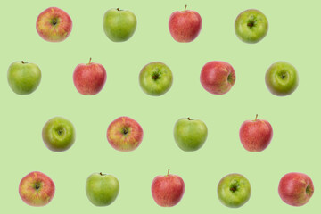 Colorful fruit pattern of fresh red, green apples on green background. texture design for textiles, wallpaper, fabric. From top view.