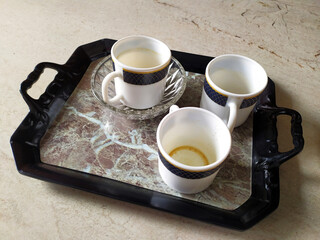 three white empty coffee mug put in a serving tray