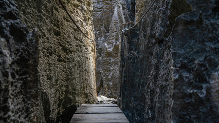 A boardwalk path is laid for tourists in the passage between the  steep slopes of the rocks. Safety...