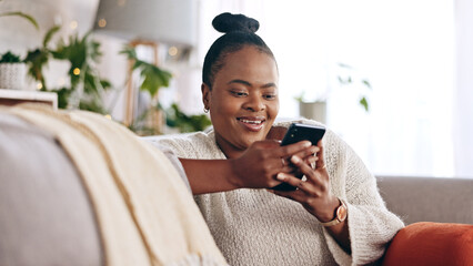 Black woman, reading and using phone with smile in home or social media, mobile app and communication online. Funny, meme or person on couch streaming video or typing on cellphone in living room