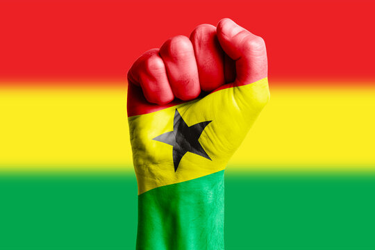 Man hand fist of GHANA flag painted. Close-up.