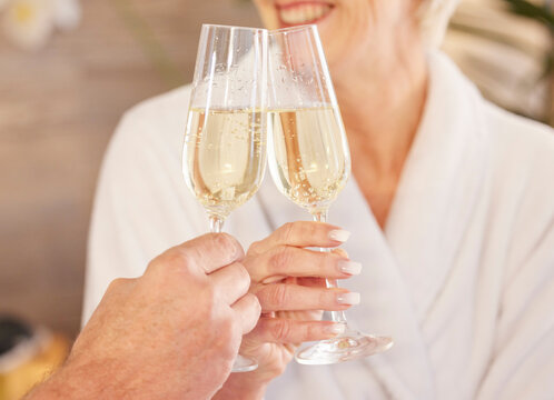 Senior couple, smile and champagne in spa for relaxing, toast and celebrate for retirement and wellness. Elderly people, peaceful and zen in luxury hotel, hospitality and care by facial or massage