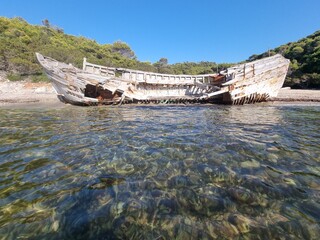 shipwreck on the beach of agalypa of skyros in greece pine trees clear transparent water in the sea