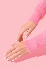 Wandcirkels tuinposter Womans hands with white manicure on pink background © Darya Lavinskaya