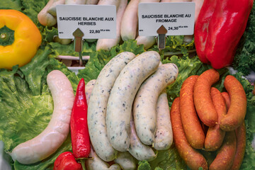 Artisanal white sausages with cheese and herbs on display at a butcher shop on the Grande Ile in...
