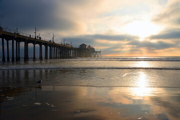 Fototapeta na wymiar Sunset from the sand in Huntington Beach Ca.