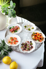 seafood appetizers on plates served in a bowl with ice