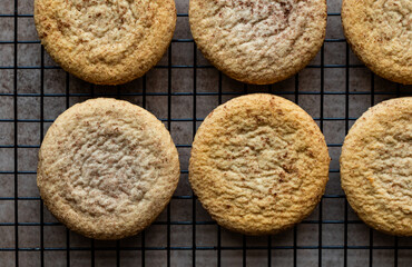 Overhead close up of snickerdoodle cookies cooling on wire rack.