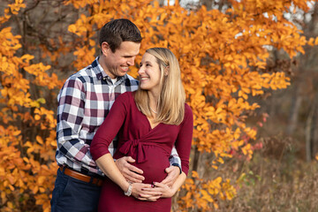 Fototapeta premium Fall Photo of excited first time parents to be smiling at each other