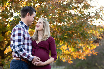 Fototapeta premium Husband looking at his smiling pregnant wife