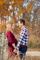 Fall Photo of excited first time parents to be looking at  each other