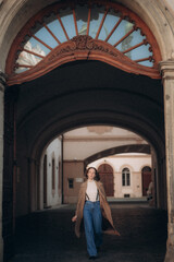 A young woman walks in the morning in sunny Prague