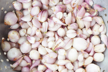 Shallots, red onions which peeled off, prepared for cooking, have to wash dirty, black mould or...