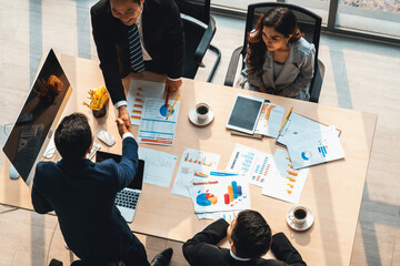 Group business people handshake at meeting table in office together with confident shot from top view . Young businessman and businesswoman workers express agreement of investment deal. Jivy