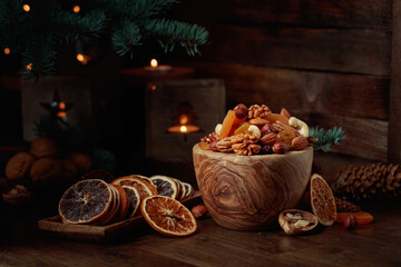 Dried fruits and assorted nuts on an old wooden table.