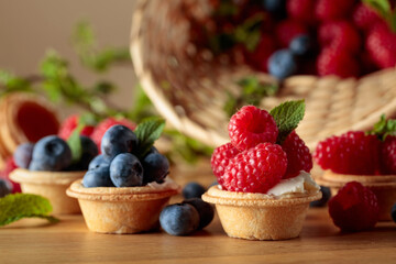 Small tartlets with fresh raspberries and blueberries.