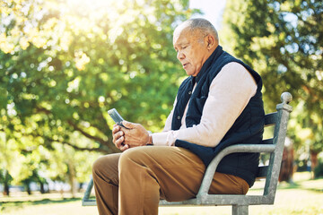 Senior man, garden and browsing on phone for social media, learning and network with internet or technology on park bench, nature and outdoors. Elderly person, email and chat on smartphone or mobile