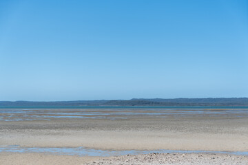 Low tide view from Tinnanbar, across the Great Sandy Strait to Fraser Island (K’gari). Queensland, Australia.