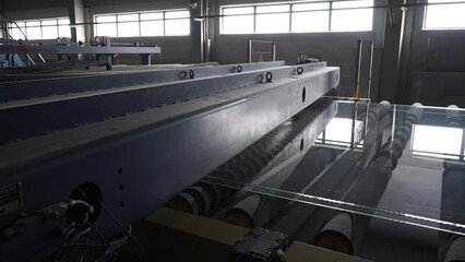 The float glass production plant. Working professionals monitor the manufacturing process and product quality.
