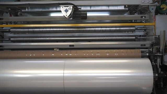 Automatic polyethylene plastic bag production machine with lighting effect.  Industrial line for the production of plastic packaging film. Factory for the production of packaging materials
