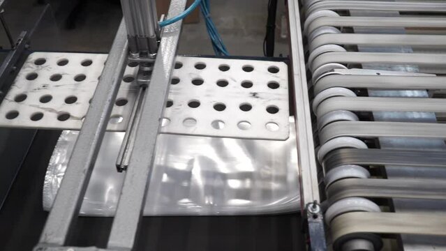Automatic polyethylene plastic bag production machine with lighting effect. product packaging concept. Plastic bag manufacturing process.
