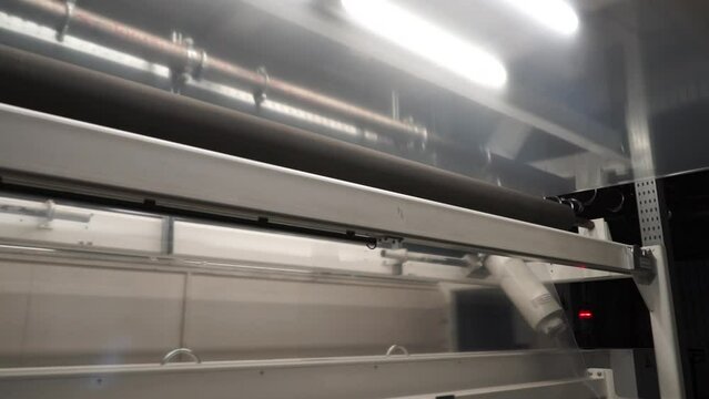 Automatic polyethylene plastic bag production machine with lighting effect.  Industrial line for the production of plastic packaging film. Factory for the production of packaging materials
