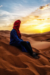 Berber man at sunset in the Sahara desert of Merzouga, Morocco.