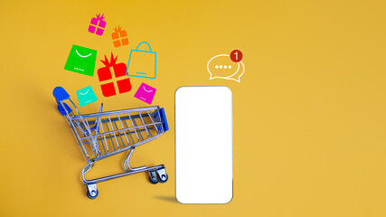 Shopping car and empty smartphone on yellow background. shopping online concept.