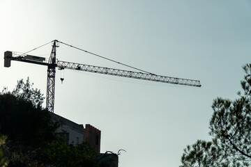 Crane for building construction, backlit.