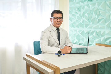 Portrait of a latin doctor in a desk