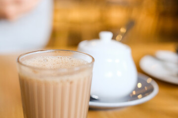 A cup of Nepalese spiced milk tea (masala chai) with sugar pot at Tapari Nights, a restaurant in Auburn, Sydney — New South Wales, Australia