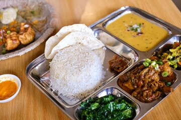 Chicken daal baht power (rice, spinach, lentil, pickle & chicken curry) served on a stainless steel tray at Tapari Nights, a Nepalese restaurant in Auburn - Sydney, New South Wales, Australia 