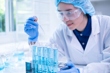 Professional scientist chemist technician analysis research experiment virus blue liquid pipette...