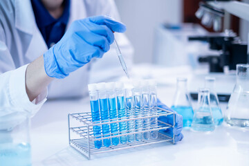 Blue glass test tube glassware liquid sample pipette equipment in chemical chemistry biotechnology...