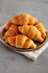 Homemade Croissants on a Plate, side view.