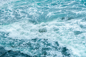 Beautiful blue wave water for abstract background from natural sea ocean in summer, motion texture pattern from outdoor seascape beach travel, aerial view bright splash surface beauty lanscape