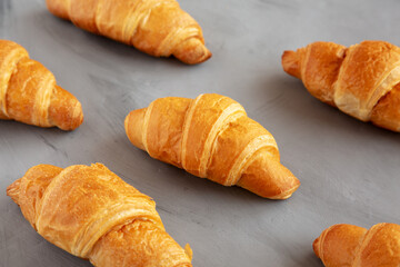 Homemade Croissants on a gray background, side view.