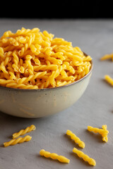Uncooked Dry Gemelli Pasta in a Bowl, side view.