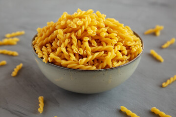 Uncooked Dry Gemelli Pasta in a Bowl, side view.