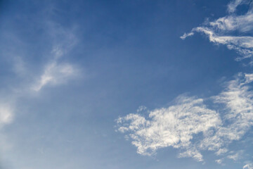 Blue sky with fluffy clouds; soft white clouds on blue sky. Skyscraper background.