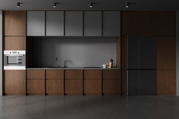 Wooden and gray kitchen interior with fridge and cabinets