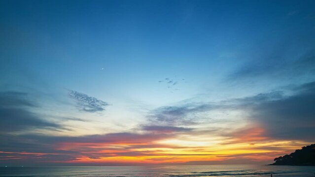 .time lapse sweet sky in beautiful sunset above the ocean at Karon beach Phuket. .abstract nature background..Sunset with sweet color light rays and other atmospheric effects..4k resolution.